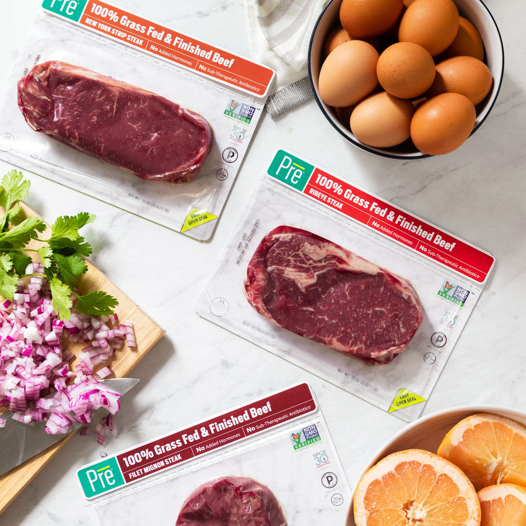 Pre Brands steak packaging with eggs and sliced vegetables on marble