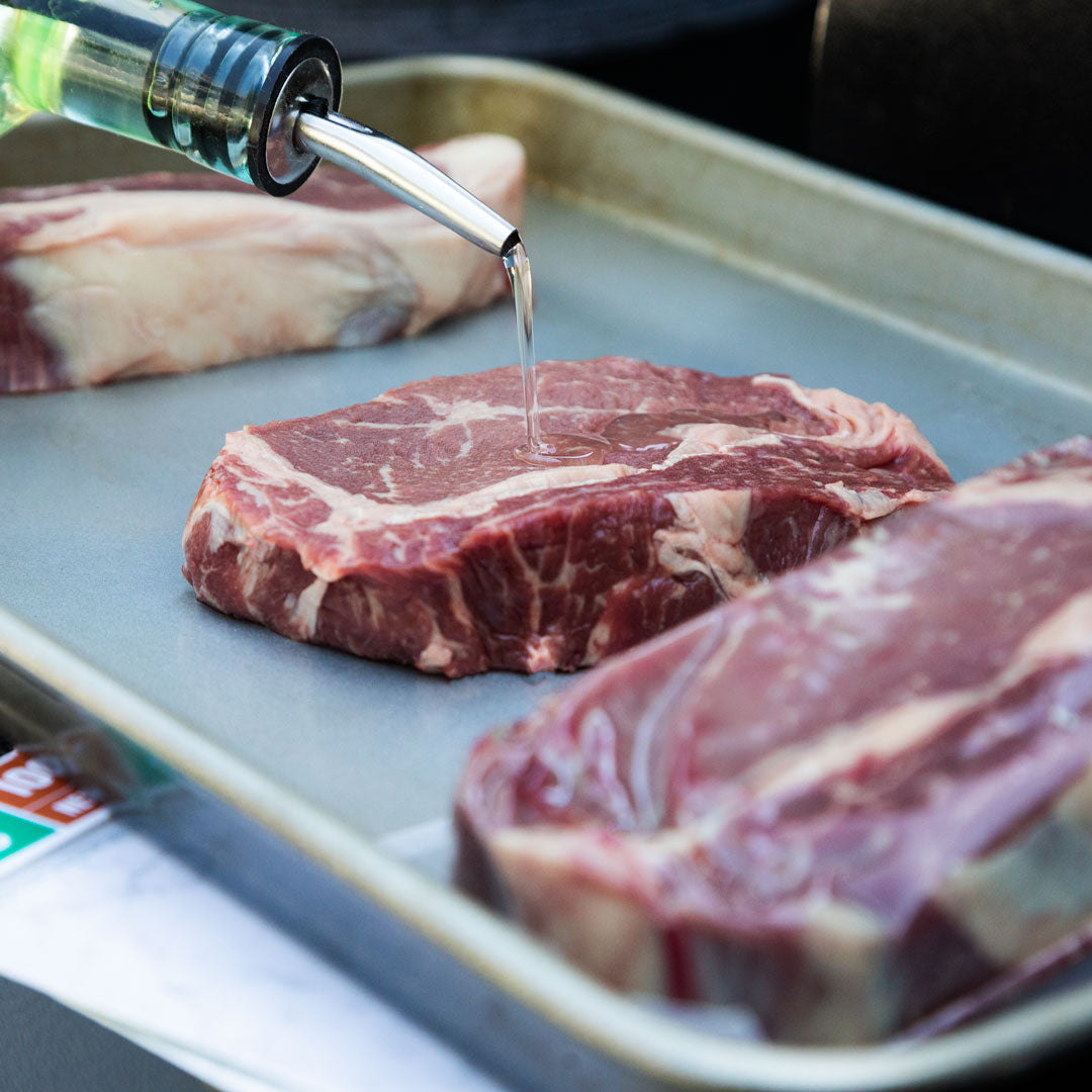 Steak with oil being poured onto it