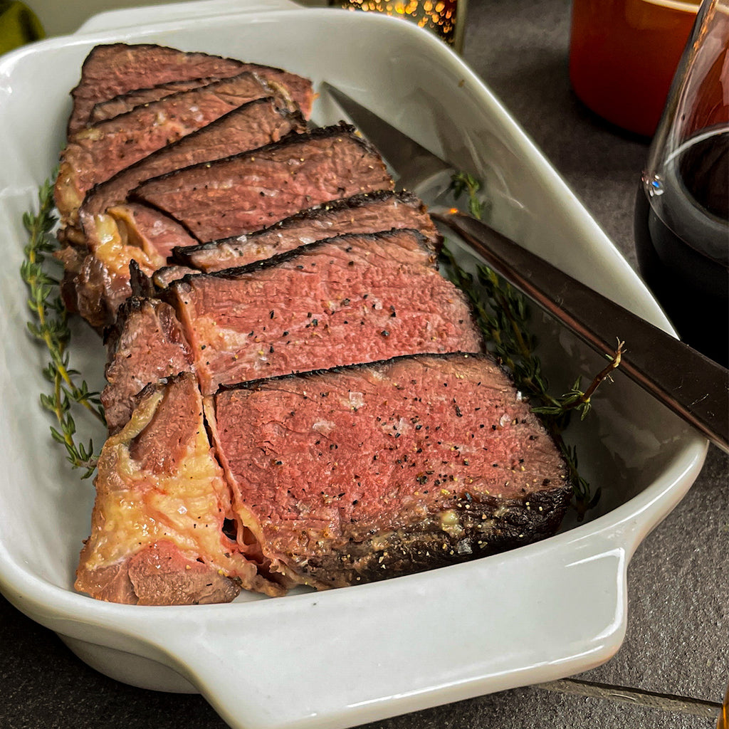 A large platter of slices of chuck roast with spices and herbs.