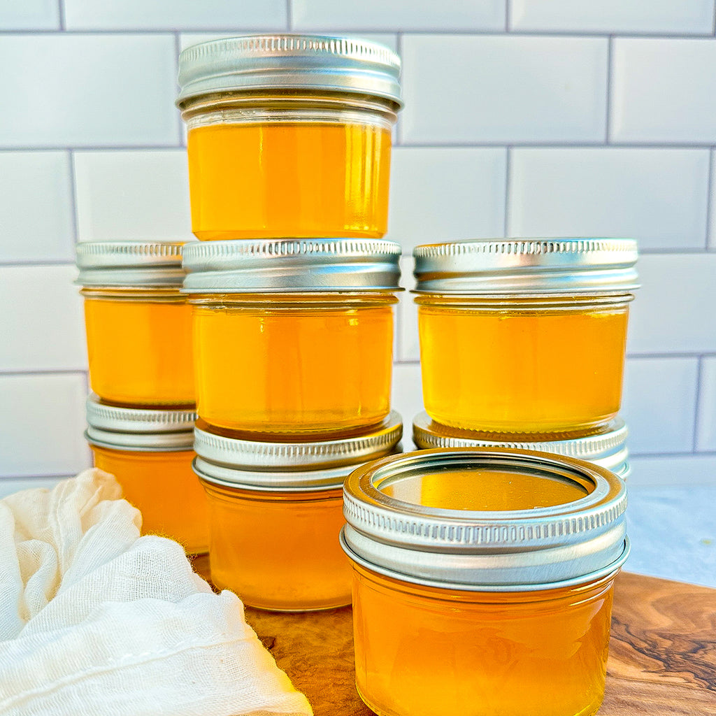 A tower of small mason jars filled with ghee.