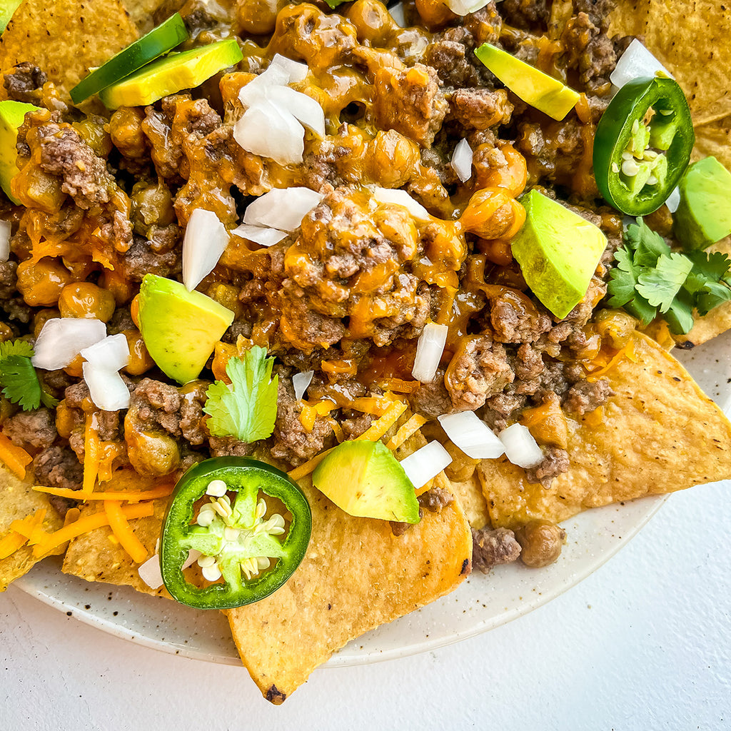 A plate of nachos with fixings