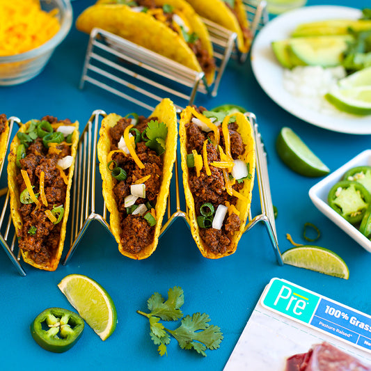 A spread of tacos and limes on a bright blue background and Pre packaging