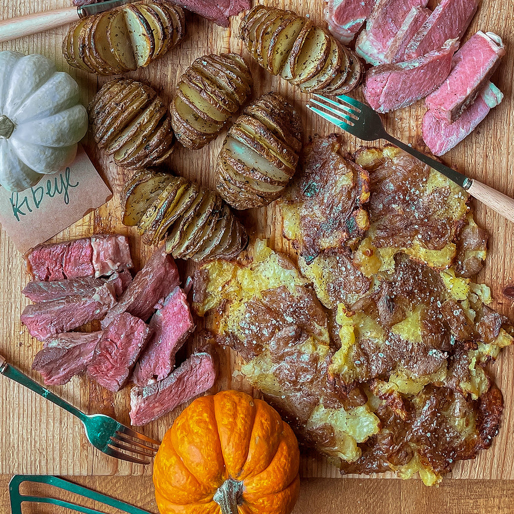 A board full of smashed potatoes and steak